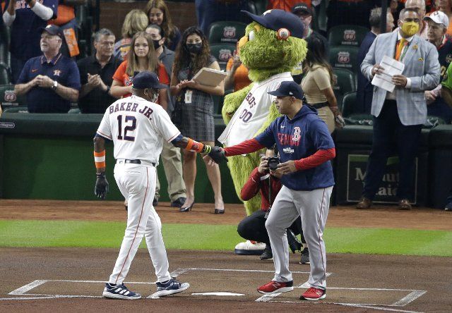Houston Astros manager Dusty Baker shakes hands with Boston Red Sox manager Alex Cora before game one of the MLB ALCS at Minute Maid Park in Houston, Texas on Friday, October 15, 2021. Photo by Johnny Angelillo