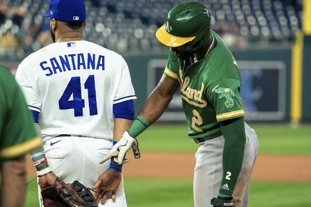 Kansas City Royals first baseman Carlos Santana (41) and Oakland Athletics center fielder Starling Marte (2) poke fun at each other at first base during the fifth inning at Kauffman Stadium in Kansas City, Missouri on Tuesday, September 14, 2021. Photo by Kyle Rivas
