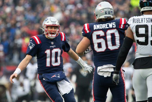 New England Patriots quarterback Mac Jones (10) celebrates a with offensive lineman David Andrews (60) after Jones threw a TD pass to Jakobi Meyers (not pictured) in the second quarter against the Jacksonville Jaguars at Gillette Stadium in Foxborough, Massachusetts on Sunday, January 2, 202. Photo by Matthew Healey