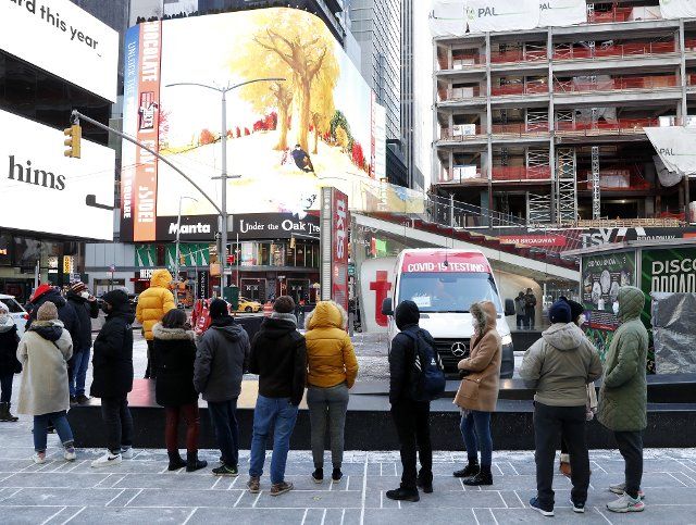 People wait in line to be tested for COVID-19 at a mobil testing site parked Times Square in New York City on Tuesday, January 4, 2022. The United States continues to set records for positive COVID cases. Photo by John Angelillo
