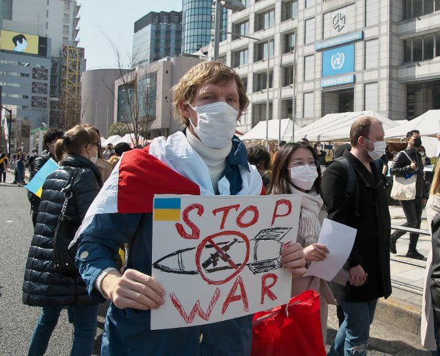 Ukrainians and participants attend a march to protest Russia\
