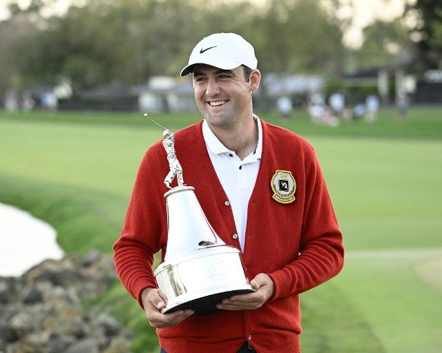 Scottie Scheffler holds the Arnold Palmer Invitational trophy for winning the Tournament presented by Mastercard at the Bay Hill Club and Lodge in Orlando, Florida on Sunday, March 6, 2022. Photo by Joe Marino