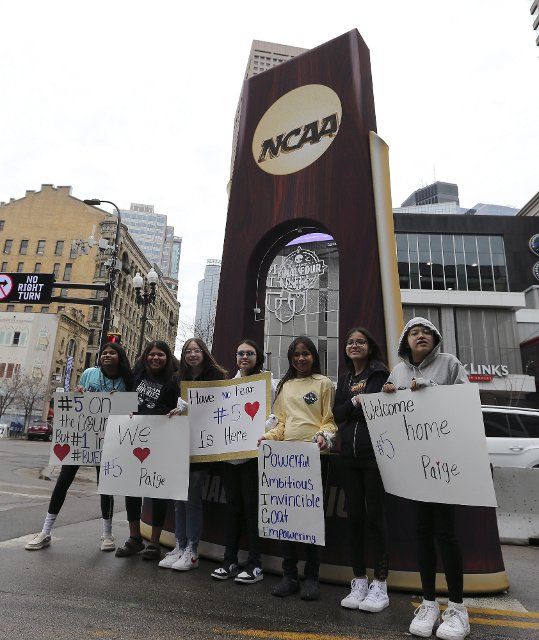 A group of young UCONN fans pose for a photo outside the Target Center prior to the National championship game of the Women\