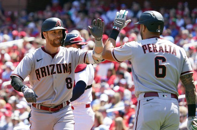 Arizona Diamondbacks Jordan Luplow (8) is congratulated by teammate David Peralta after hitting a solo home run in the first inning against the St. Louis Cardinals at Busch Stadium in St. Louis on May 1, 2022. St. Louis defeated Arizona 7-5. Photo by Bill Greenblatt