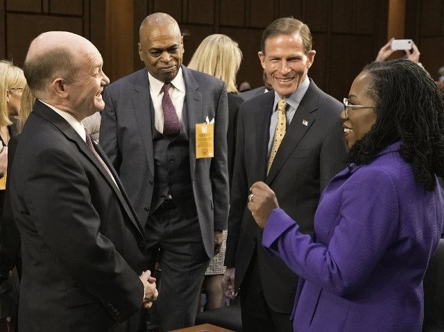 Supreme Court nominee Ketanji Brown Jackson speaks with Sen. Christopher Coons, D-DE, (L) and Sen. Richard Blumenthal, D-CT, (R) as she arrives for a Senate Judiciary Committee confirmation hearing on Capitol Hill in Washington DC, Monday, March 21, 2022. Jackson was nominated by President Joe Biden to fill Supreme Court Justice Stephen Breyer\