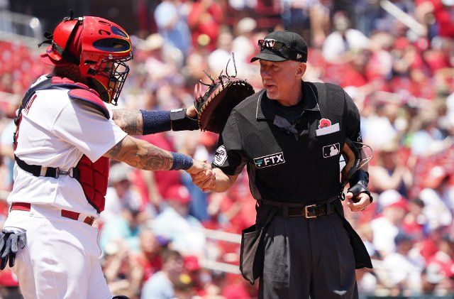 Major League home plate umpire Lance Barksdale greets St. Louis Cardinals catcher Yadier Molina just before a game against the San Diego Padres at Busch Stadium in St. Louis on Monday, May 30, 2022. Photo by Bill Greenblatt