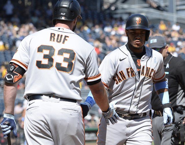 San Francisco Giants left fielder Darin Ruf (33) greets following San Francisco Giants shortstop Thairo Estrada (39) homers in the top of the ninth inning that ties the score 3-3 with the Pittsburgh Pirates at PNC Park on Sunday June 19, 2022 in Pittsburgh. Photo by Archie Carpenter