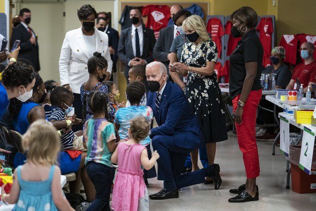 President Joe Biden meets families and clinic staff while visiting a Covid-19 vaccination site hosted by the District of Columbia\