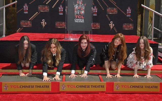 Harper Vivienne Ann Lockwood, Lisa Marie Presley, Priscilla Presley, Riley Keough, and Finley Aaron Love Lockwood (L-R) participate in a handprint ceremony immortalizing the Elvis Presley family members in the forecourt of the TCL Chinese Theatre (formerly Grauman\