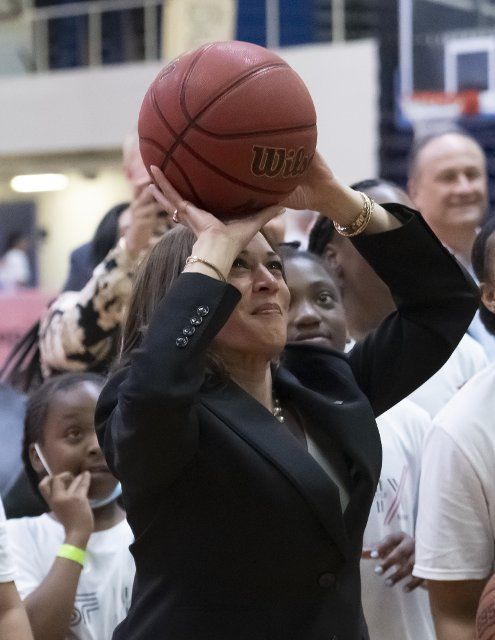 United States Vice President Kamala Harris attempts to make a basket as she makes a surprise visit to a Field Day hosted by the Department of Education and the Women\