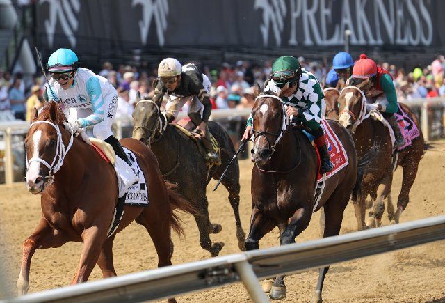 Lightening Larry, ridden by Chantal Sutherland, crosses the finish line to win the Chick Lang Stakes at Pimlico Race Course in Baltimore, Maryland, on Preakness Day. May 21, 2022. Photo by Mark Abraham