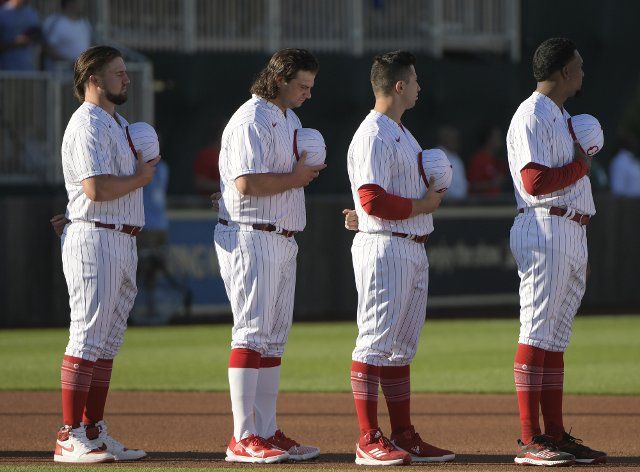 Cincinnati Reds players stand on the field for the National Anthem before the regular season game against the Chicago Cubs at MLB Field of Dreams Stadium in Dyersville, Iowa on Thursday, August 11, 2022. Photo by Mark Black