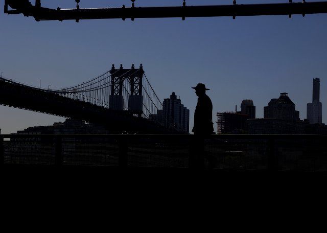Pedestrians walk under the FDR Drive with a view of the East River and the Brooklyn Bridge in New York City on Friday, August 19, 2022. Photo by John Angelillo