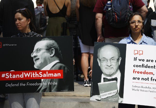 Supporters of author Salman Rushdie hold signs when they attend a New York literary event rally held in support of Salman Rushdie following last week\