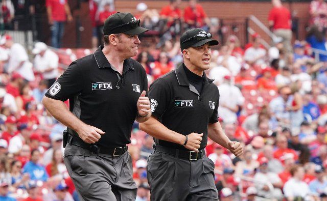Umpires Chris Conroy (L) and Chris Segal run to their position for a game between the Chicago Cubs and the St. Louis Cardinals at Busch Stadium in St. Louis on Sunday, June 26, 2022. Photo by Bill Greenblatt