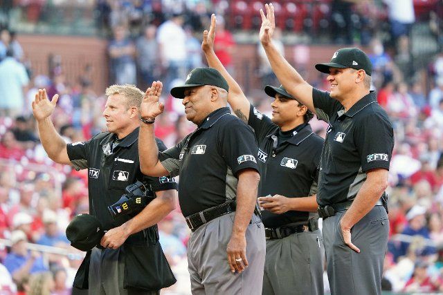 Major League umpires (L to R) Tripp Gibson, Laz Diaz, Erich Bacchus and Chad Fairchild, wave to family members in the stands before a game between the Miami Marlins and St. Louis Cardinals at Busch Stadium in St. Louis on Monday, June 27, 2022. Photo by Bill Greenblatt