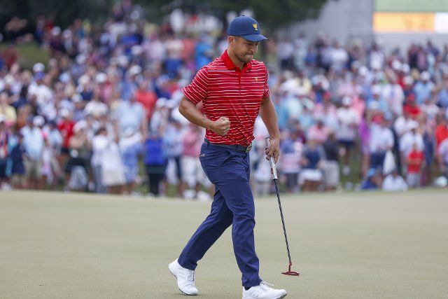 Xander Schauffele reacts after winning the hole on the 15th hole as the United States wins the Presidents Cup golf championship in Charlotte, North Carolina on Sunday, September 25, 2022. Photo by Nell Redmond
