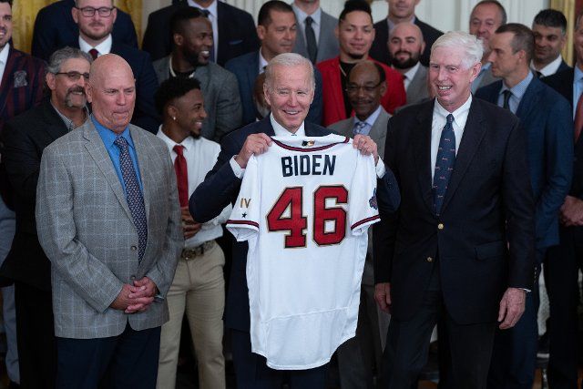 United States President Joe Biden poses for photos with a team jersey presented to him during a ceremony welcoming the Atlanta Braves to the White House in Washington, DC to celebrate their 2021 World Series championship, September 26, 2022. Photo by Chris Kleponis