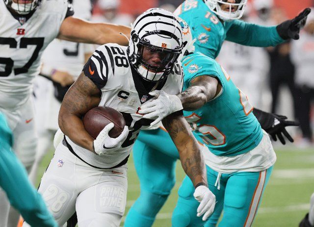 Cincinnati Bengals halfback Joe Mixon (28) fights to break free from Miami Dolphins Xavien Ingram (25) during the first half of play at Paycor Stadium, Thursday, September 29, 2022 in Cincinnati, Ohio. Photo by John Sommers II