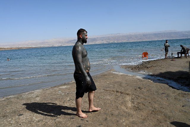 A Palestinians wears black mud at the Biankini Village Resortâs private beach on the Dead Sea, West Bank near Jericho, on Thursday, September 29, 2022. Israeli owner, Dina Dagan says 80% of her bookings are made through Booking.com and that she is seeing a drop in reservations since Booking.com, the online travel agency announced that it will add warnings to listings in the Israeli occupied West Bank, cautioning customers reserving accommodations in Israeli Settlements that they are traveling to a disputed high risk area. Israeli Tourism Minister Yoel Razvozov says he\