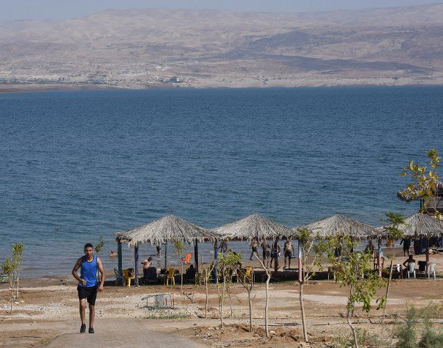 A visitor walks near the Dead Sea at the private beach of the Biankini Village Resort in the West Bank near Jericho, on Thursday, September 29, 2022. Israeli owner, Dina Dagan says 80% of her bookings are made through Booking.com and that she is seeing a drop in reservations since Booking.com, the online travel agency announced that it will add warnings to listings in the Israeli occupied West Bank, cautioning customers reserving accommodations in Israeli Settlements that they are traveling to a disputed high risk area. Israeli Tourism Minister Yoel Razvozov says he\