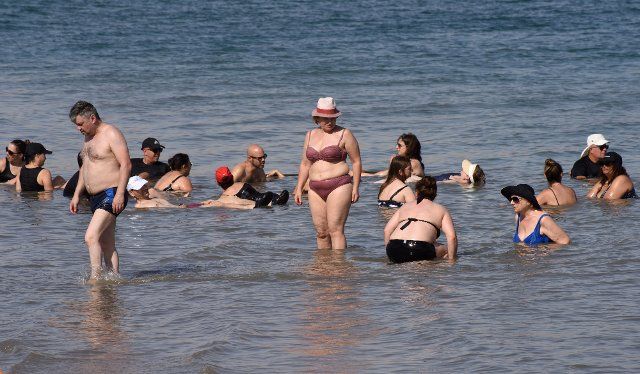 Tourists enjoy the Dead Sea at the private beach of the Biankini Village Resort in the West Bank near Jericho, on Thursday, September 29, 2022. Israeli owner, Dina Dagan says 80% of her bookings are made through Booking.com and that she is seeing a drop in reservations since Booking.com, the online travel agency announced that it will add warnings to listings in the Israeli occupied West Bank, cautioning customers reserving accommodations in Israeli Settlements that they are traveling to a disputed high risk area. Israeli Tourism Minister Yoel Razvozov says he\