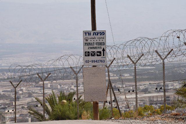 A sign for a B&B is hung on a pole beside a security fence surrounding the Vered Yericho Jewish settlement in the Jordan Valley, West Bank, that houses several B&B hosts, on Thursday, September 29, 2022. Booking.com, the online travel agency, has announced that it will add warnings to listings in the Israeli occupied West Bank, cautioning customers reserving accommodations in Israeli Settlements that they are traveling to a disputed high risk area. Israeli Tourism Minister Yoel Razvozov says he\