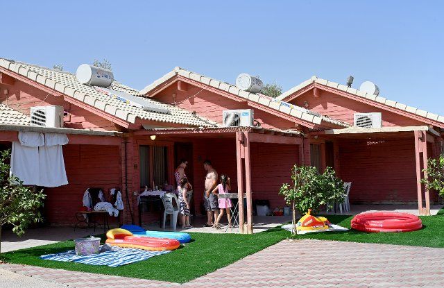 Guests stand outside their cabin at the Biankini Village Resort on the Dead Sea, in West Bank near Jericho, on Thursday, September 29, 2022. Israeli owner, Dina Dagan says 80% of her bookings are made through Booking.com and that she is seeing a drop in reservations since Booking.com, the online travel agency announced that it will add warnings to listings in the Israeli occupied West Bank, cautioning customers reserving accommodations in Israeli Settlements that they are traveling to a disputed high risk area. Israeli Tourism Minister Yoel Razvozov says he\