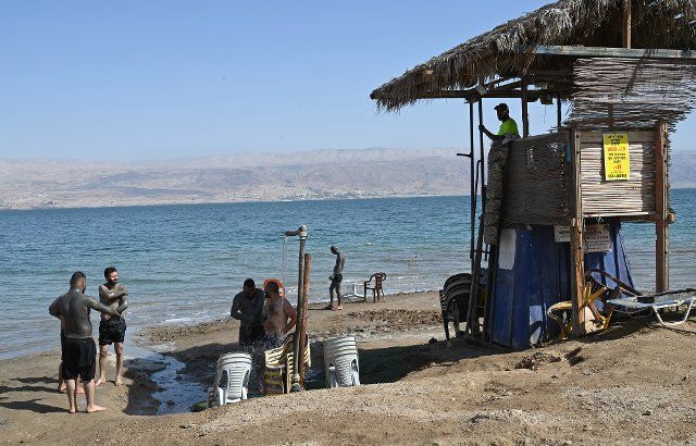 Victors apply black mud at the Biankini Village Resortâs private beach on the Dead Sea, West Bank near Jericho, on Thursday, September 29, 2022. Israeli owner, Dina Dagan says 80% of her bookings are made through Booking.com and that she is seeing a drop in reservations since Booking.com, the online travel agency announced that it will add warnings to listings in the Israeli occupied West Bank, cautioning customers reserving accommodations in Israeli Settlements that they are traveling to a disputed high risk area. Israeli Tourism Minister Yoel Razvozov says he\