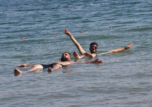 Palestinians float in the Dead Sea at the private beach of the Biankini Village Resort in the West Bank near Jericho, on Thursday, September 29, 2022. Israeli owner, Dina Dagan says 80% of her bookings are made through Booking.com and that she is seeing a drop in reservations since Booking.com, the online travel agency announced that it will add warnings to listings in the Israeli occupied West Bank, cautioning customers reserving accommodations in Israeli Settlements that they are traveling to a disputed high risk area. Israeli Tourism Minister Yoel Razvozov says he\