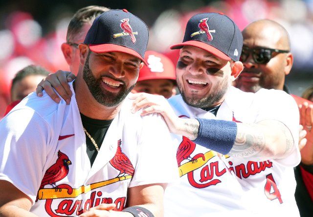 St. Louis Cardinals Albert Pujols (L) jokes with teammate Yadier Molina as the two participate in a farewell ceremony before a game against the Pittsburgh Pirates at Busch Stadium in St. Louis on Sunday, October 2, 2022. Both longtime players have announced their retirement following this season. Photo by Bill Greenblatt