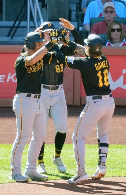 Pittsburgh Pirates Ben Gamel is welcomed at homeplate by teammates Cal Mitchell and Jack Suwinski after hitting a three run home run in the second inning against the St. Louis Cardinals at Busch Stadium in St. Louis on Sunday, October 2, 2022. Photo by Bill Greenblatt