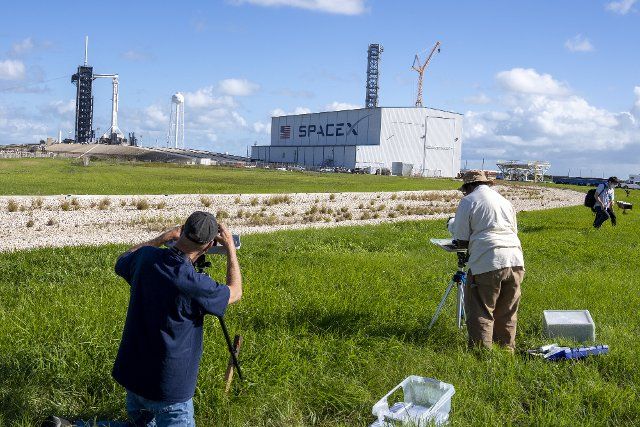 Photographers set up remote cameras as a SpaceX Falcon 9 rocket sits on Launchpat 39A with a Crew-5 Dragon capsule on top at the Kennedy Space Center, Florida on Tuesday, October 4, 2022. An international crew including a Japanese and Russian is expected to lift off on October 5, 2022 on a a mission to the International Space Station. . Photo by Pat Benic