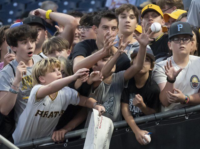 Pittsburgh Pirates players toss baseballs to fans following the 5-3 win against the St. Louis Cardinals at PNC Park on Wednesday October, 5 2022 in Pittsburgh. Photo by Archie Carpenter