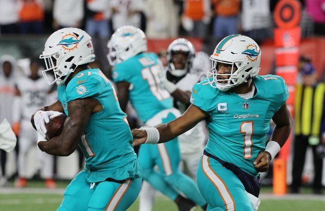 Miami Dolphins quarterback Tua Tagovailoa (1) hands off the football during their game against the Cincinnati Bengals at Paycor Stadium, Thursday, September 29, 2022 in Cincinnati, Ohio. Photo by John Sommers II