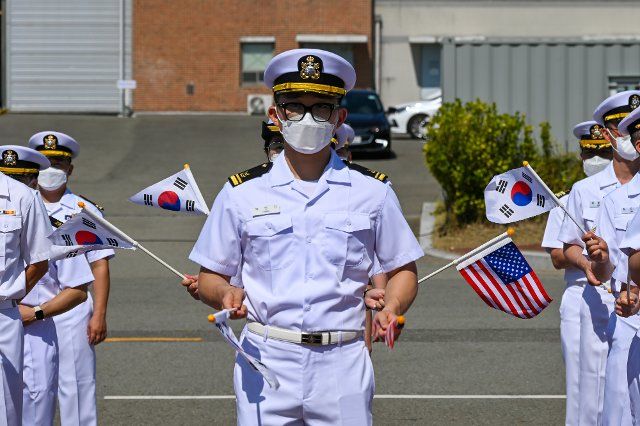 South Korean sailors welcome the arrival of the USS Ronald Reagan aircraft carrier to Busan, South Korea on Friday, September 23, 2022. Photo by Thomas Maresca