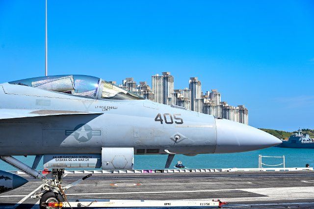 An F-18 fighter is on the deck of the USS Ronald Reagan aircraft carrier in Busan, South Korea on Friday, September 23, 2022. The visit is the nuclear-powered carrier\