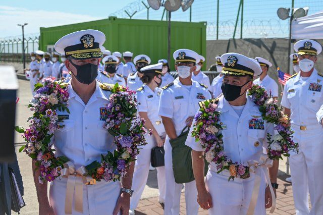Rear Adm. Buzz Donnelly and Capt. Fred Goldhammer receive wreaths during the arrival ceremony for the USS Ronald Reagan aircraft carrier in Busan, South Korea on Friday, September 23, 2022. Photo by Thomas Maresca