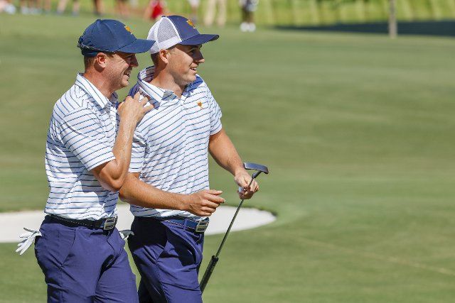 Justin Thomas, left, hugs Jordan Spieth after Spieth made a putt on the 12th hole during Four-Ball match play at the Presidents Cup golf championship in Charlotte, North Carolina on Friday, September 23, 2022. Photo by Nell Redmond\/UPI