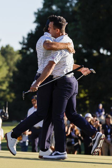Max Homa, left, hugs teammate Billy Horschel after their pairing won their Four-Ball match play at the Presidents Cup golf championship in Charlotte, North Carolina on Friday, September 23, 2022. Photo by Nell Redmond\/UPI