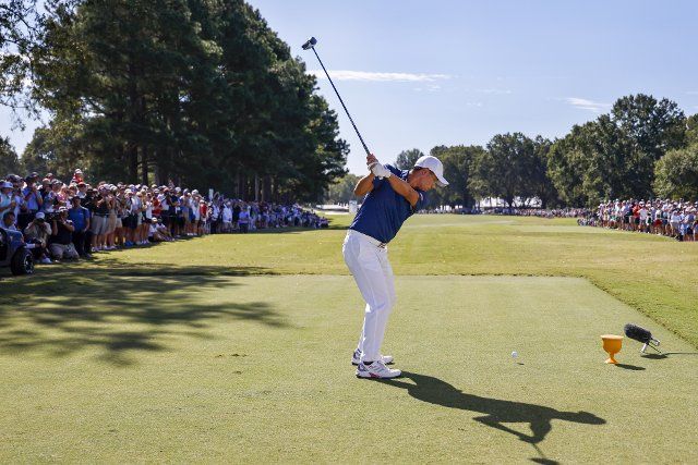 Collin Morikawa tees off on the 16th during his foursomes match at the Presidents Cup golf championship in Charlotte, North Carolina on Saturday, September 24, 2022. Photo by Nell Redmond