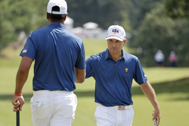 Kevin Kisner, right, congratulates Tony Finau after Finau made a birdie during four-ball match play at the Presidents Cup golf championship in Charlotte, North Carolina on Saturday, September 24, 2022. Photo by Nell Redmond