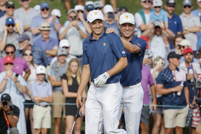 Jordan Spieth, left, and Justin Thomas celebrate winning a point for the United States during four-ball match play at the Presidents Cup golf championship in Charlotte, North Carolina on Saturday, September 24, 2022. Photo by Nell Redmond