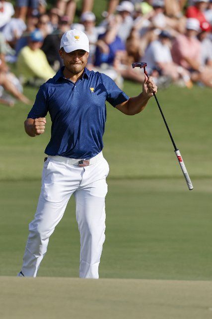 Xander Schauffele reacts to making a putt on the 15th hole during four-ball match play at the Presidents Cup golf championship in Charlotte, North Carolina on Saturday, September 24, 2022. Photo by Nell Redmond