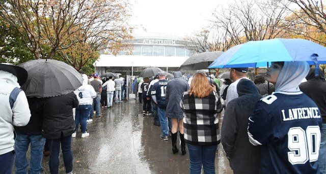 Fans wait in the rain to enter the Dallas Cowboys and New York Giants game NFL game at AT&T Stadium in Arlington, Texas on Thursday November 24, 2022. Photo by Ian Halperin