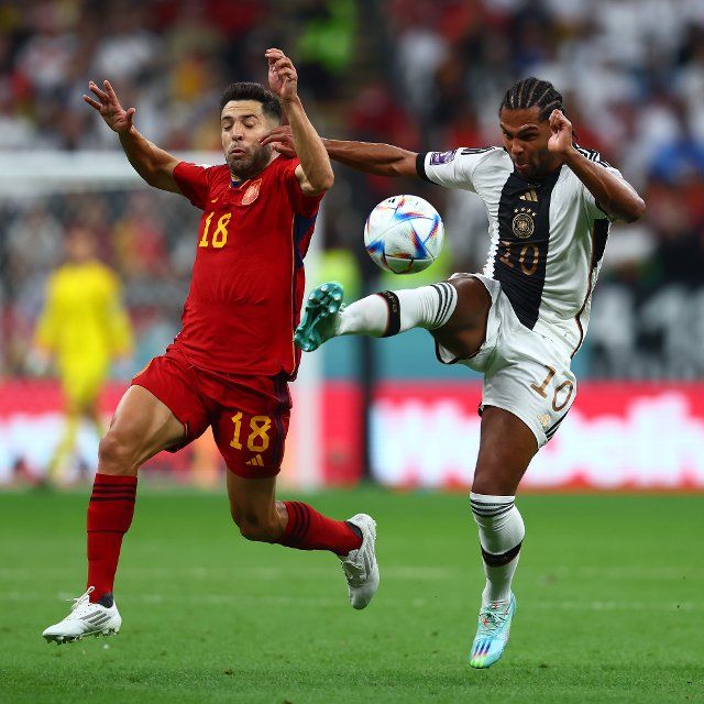 Jordi Alba (L) of Spain in action with Serge Gnabry of Germany during the 2022 FIFA World Cup Group E match at Al Bayt Stadium in Doha, Qatar on November 27, 2022. Photo by Chris Brunskill