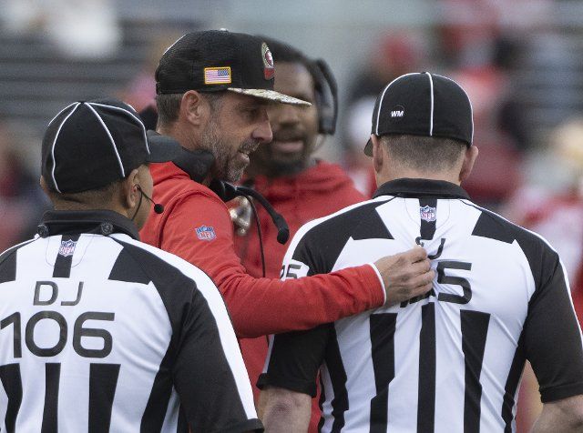 San Francisco 49ers head coach Kyle Shanahantugs on the uniform of side judge Chad Hill while pleading a call in the first half against the New Orleans Saints at Levi\