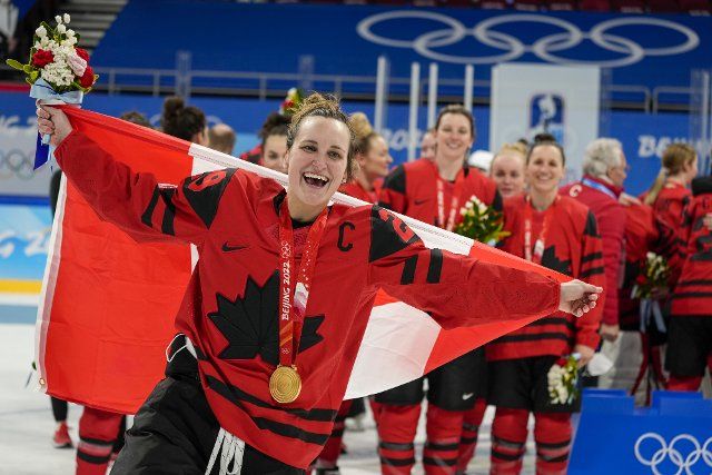 Canada forward Marie-Philip Poulin (29) celebrares with team-mates after winning the gold medal in their Women\