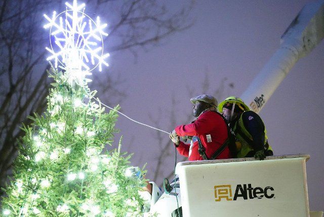 East St. Louis Mayor Robert Eastern III, with the assistance of a bucket truck, turns on the 50-foot Christmas tree in East St. Louis, Illinois on Friday, December 2, 2022. Photo by Bill Greenblatt