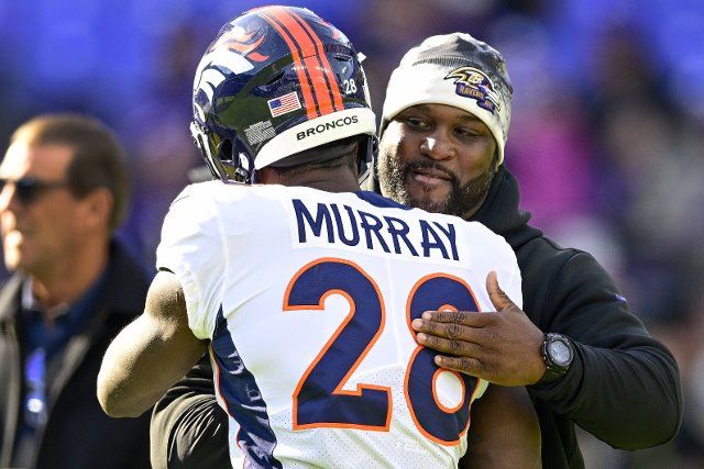 Denver Broncos running back Latavius Murray (28) greets a coaching staff member from the Baltimore Ravens, his former team, during pregame warmups at M&T Bank Stadium in Baltimore, Maryland, on Sunday, December 4, 2022. Photo by David Tulis
